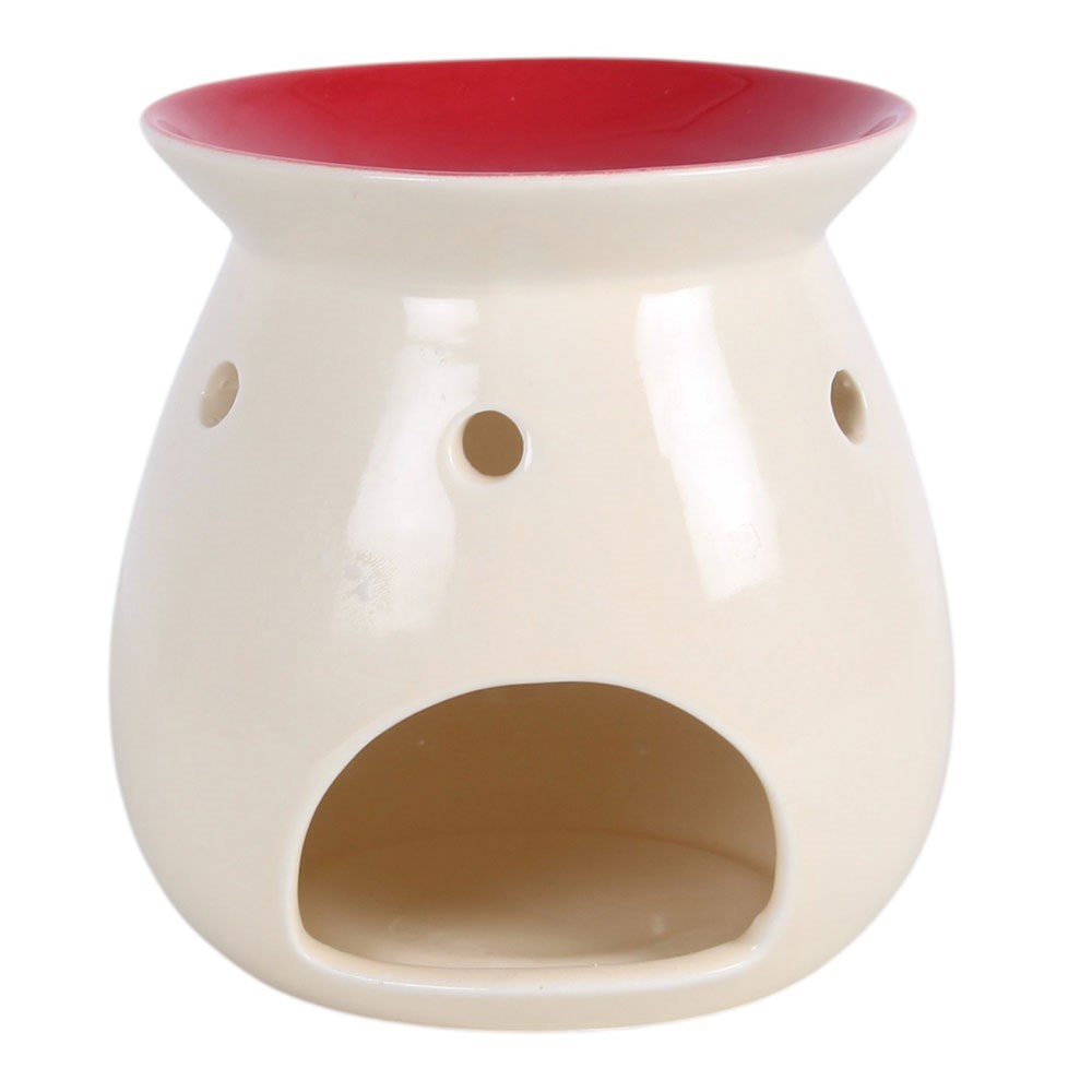 back of christmas village oil burner showing the tealight opening