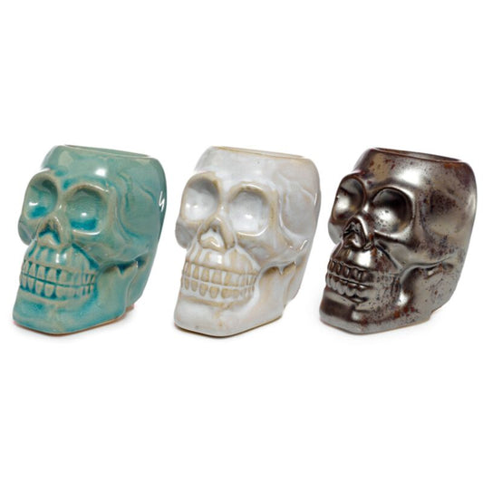 white brown and aqua mini ceramic skull oil burner variants displayed together