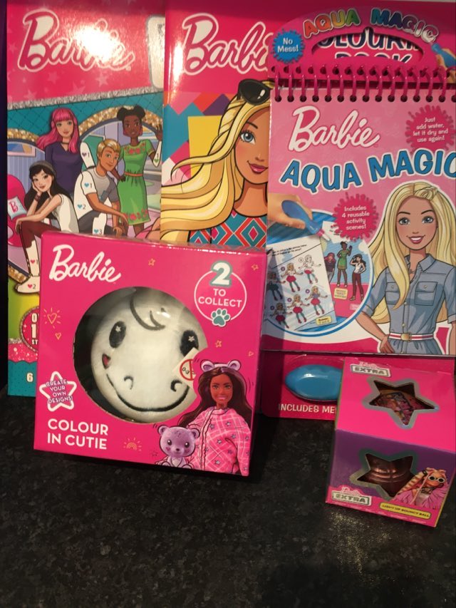 example contents of barbie mystery box showing a selection of assorted official barbie gifts and accessories
