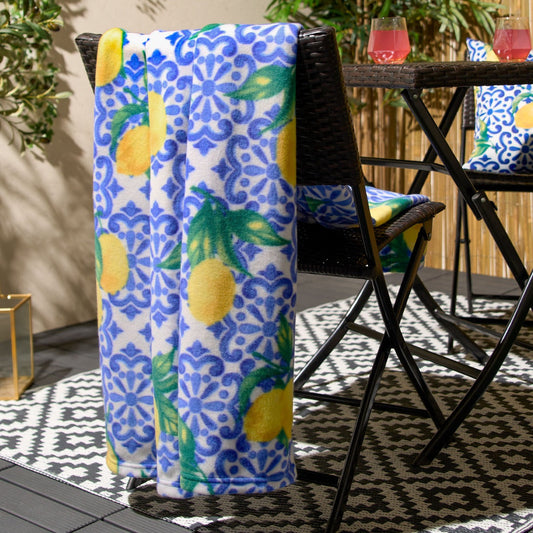 patterned fleece blanket styled over garden chair in outdoor setting