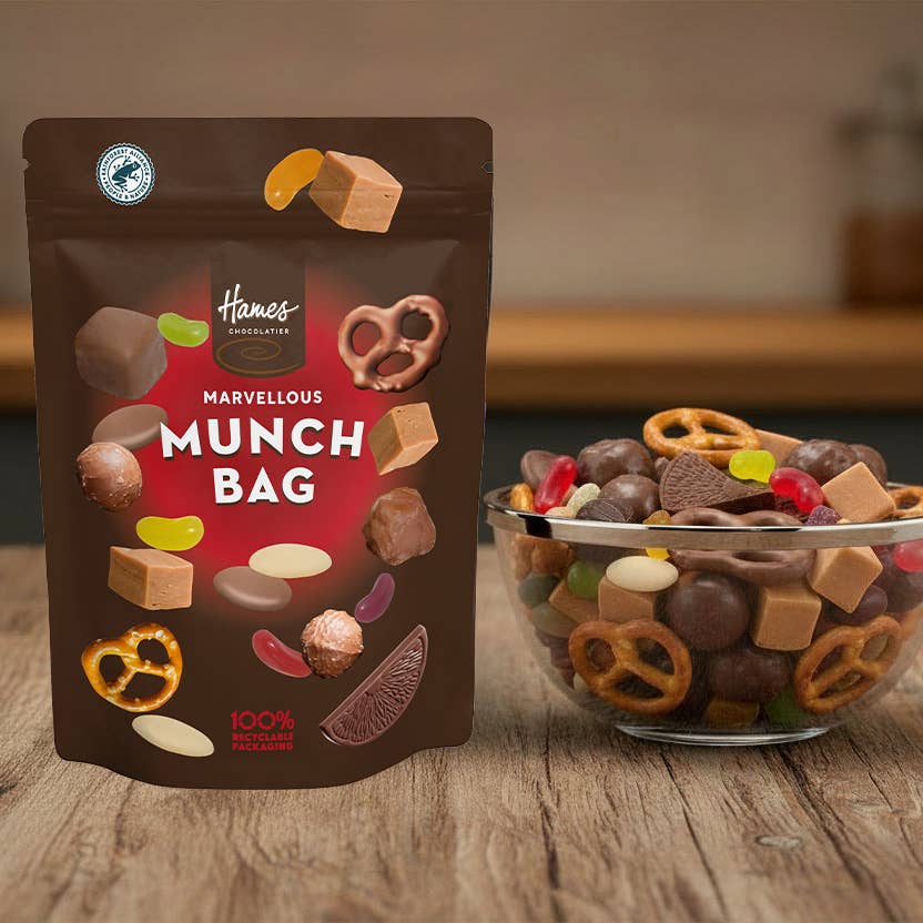 unopened marvellous munch pouch beside a bowl of assorted confectionery treats