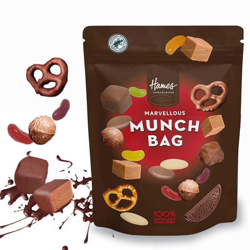 marvellous munch 100g sweet and chocolate treat pouch with chocolates beside it