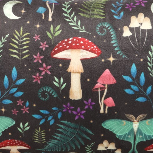close up of forest illustration cushion showing detailed mushroom and moth artwork on fabric surface