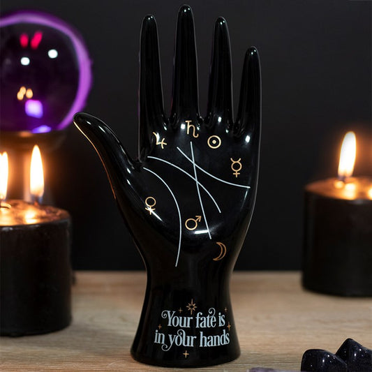 ceramic palmistry hand ornament displayed in a fortune telling style setting with astrology symbols and decorative details