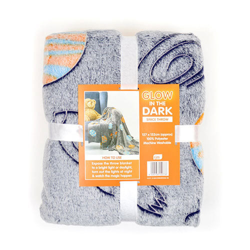 Children’s space glow in the dark fleece throw blanket laid flat, featuring planets, stars and cosmic design