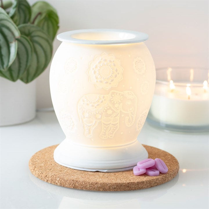 elephant wax burner lit showing decorative elephant cut out design glowing during use
