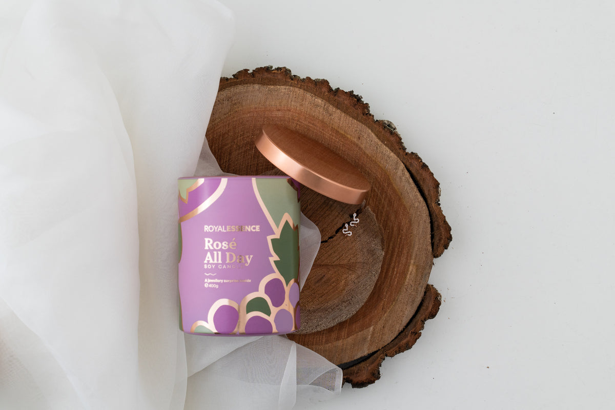 royal essence rose all day rose gold candle in home setting with soft lighting