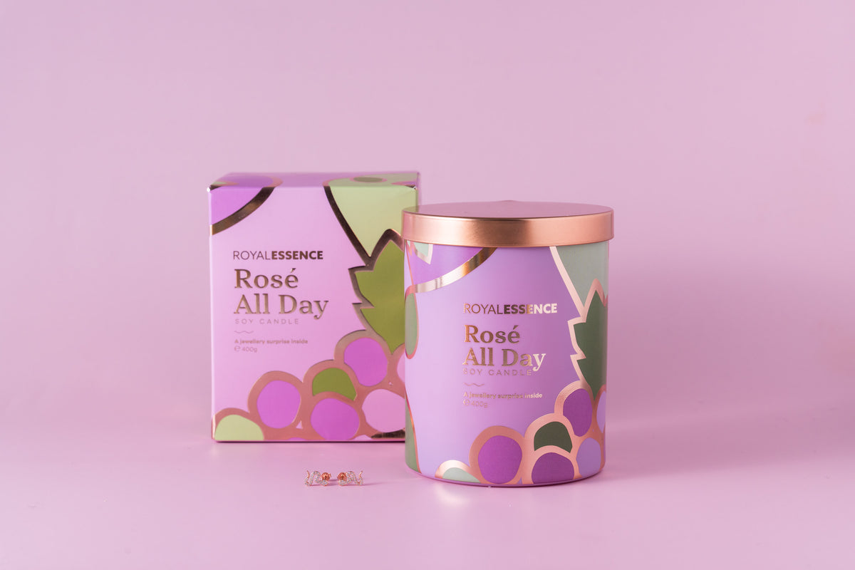 front view of royal essence rose all day rose gold candle with metallic rose gold lid and a jewellery ring variant