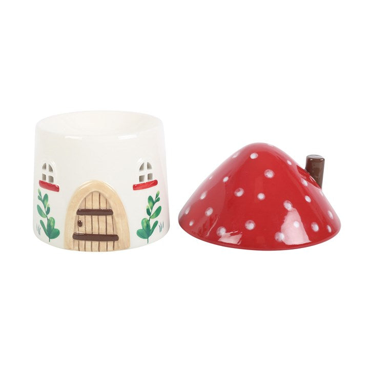 ceramic mushroom house oil burner with lid placed beside burner