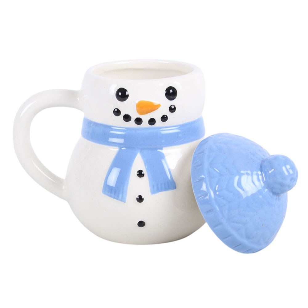blue christmas snowman mug with matching bobble hat lid placed beside it