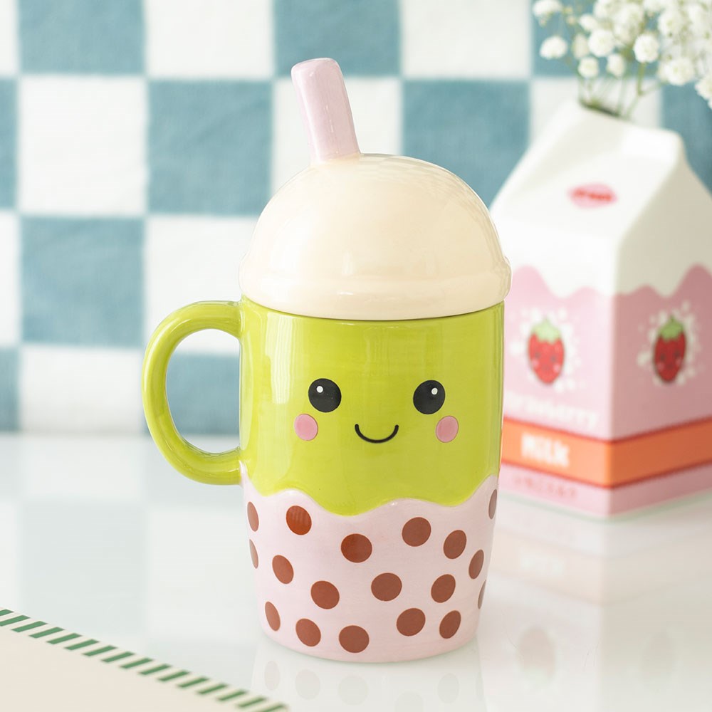 kawaii bubble tea mug with pink straw and domed lid in a cosy home setting
