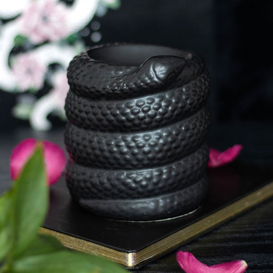 black ceramic oil burner and wax warmer shaped like a coiled snake