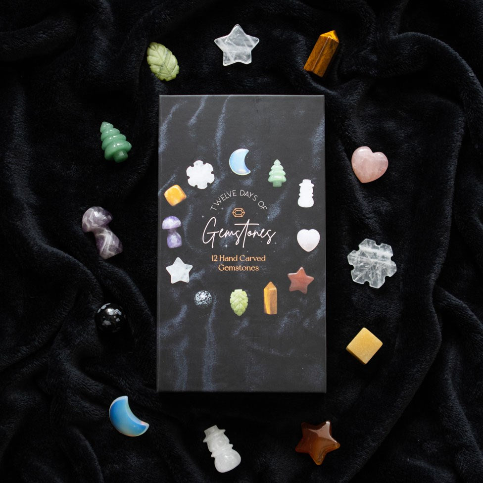 christmas crystal advent calendar with twelve carved gemstones in festive shapes