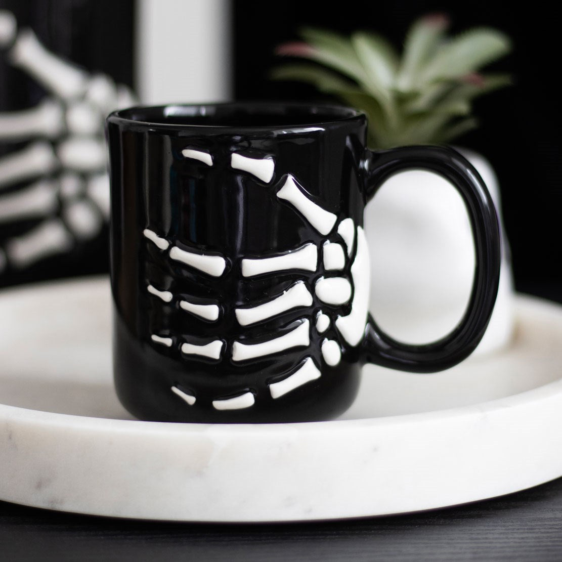 skeleton hand mug displayed on a tray in a home setting