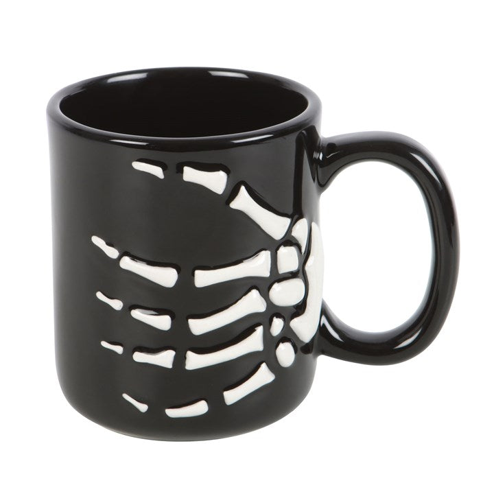 front view of ceramic skeleton hand mug showing the skeletal hand design