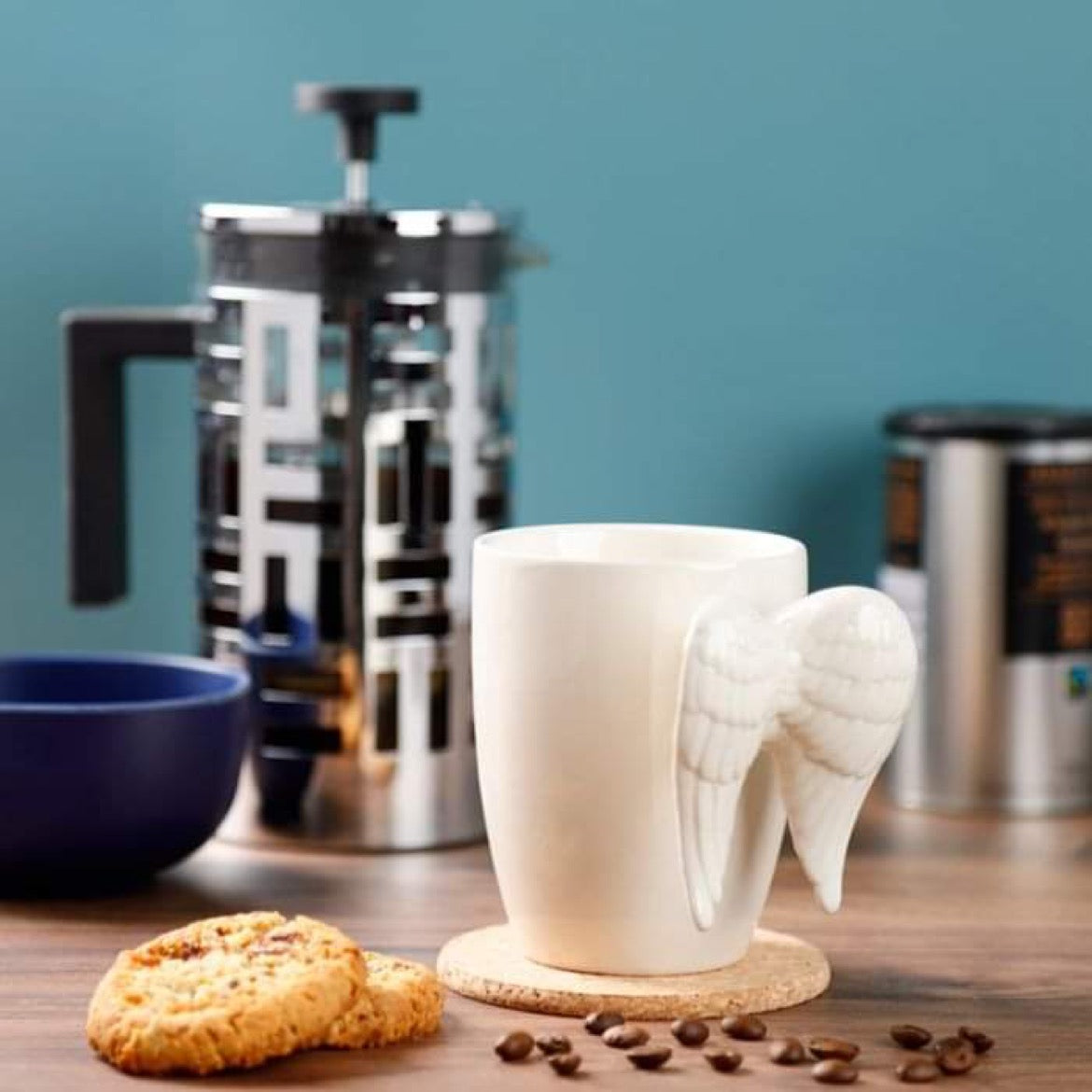 angel wings 3d ceramic mug styled in a kitchen setting beside a coffee pot for home use context