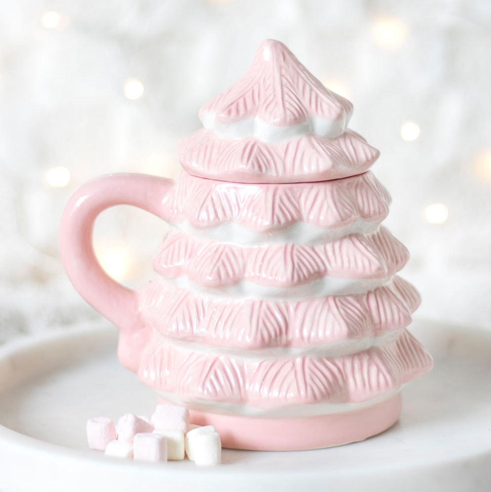 pink christmas tree shaped mug displayed on a tray in a cosy home setting