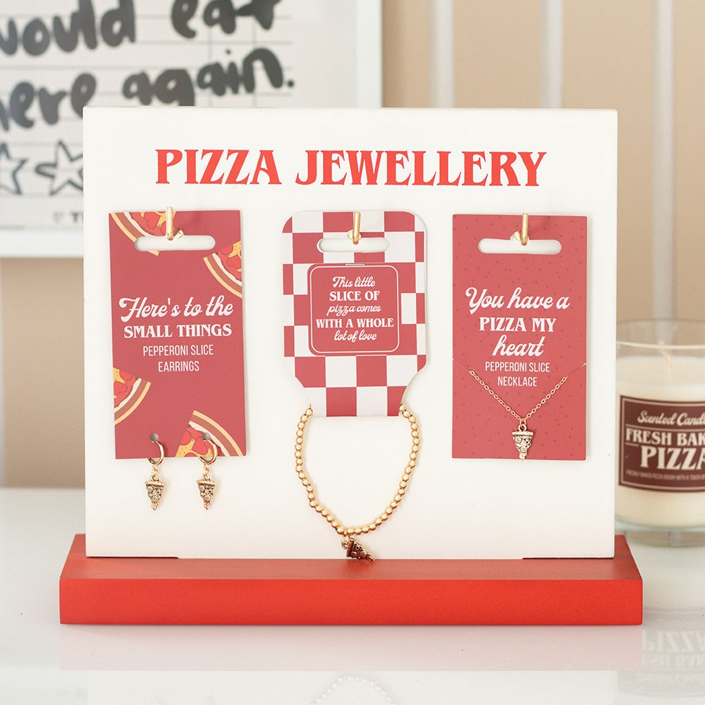 gold tone pizza slice jewellery with playful foodie slogan backing card