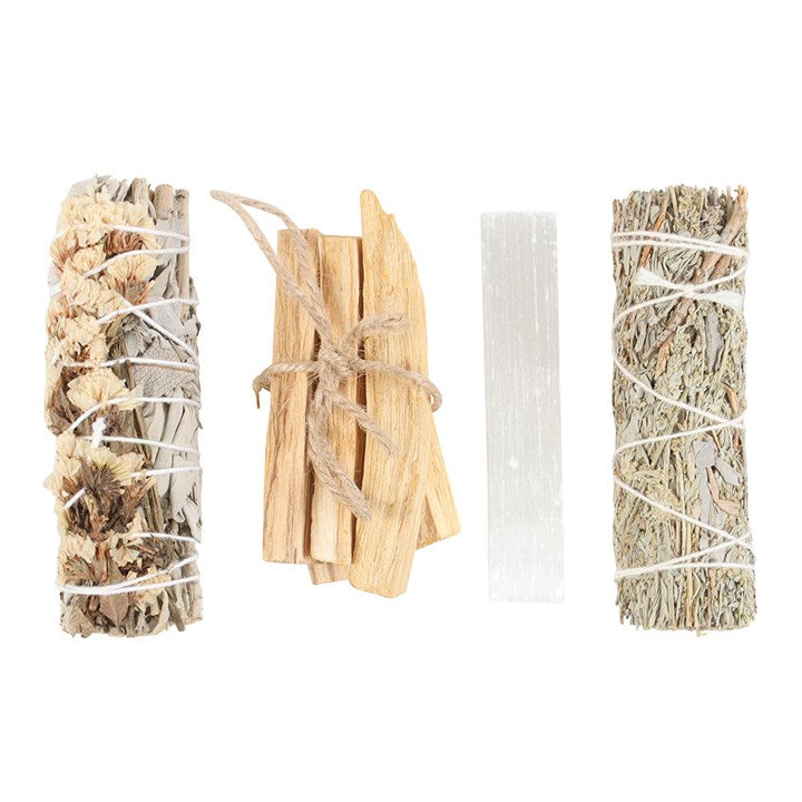 unboxed palo santo sage bundles and selenite crystal laid out for energy cleansing