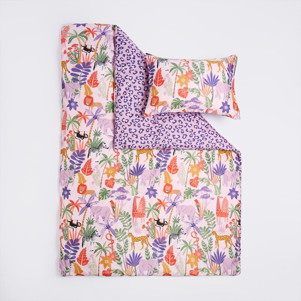 Close-up of safari print duvet cover showing lions, giraffes, zebras and leafy details