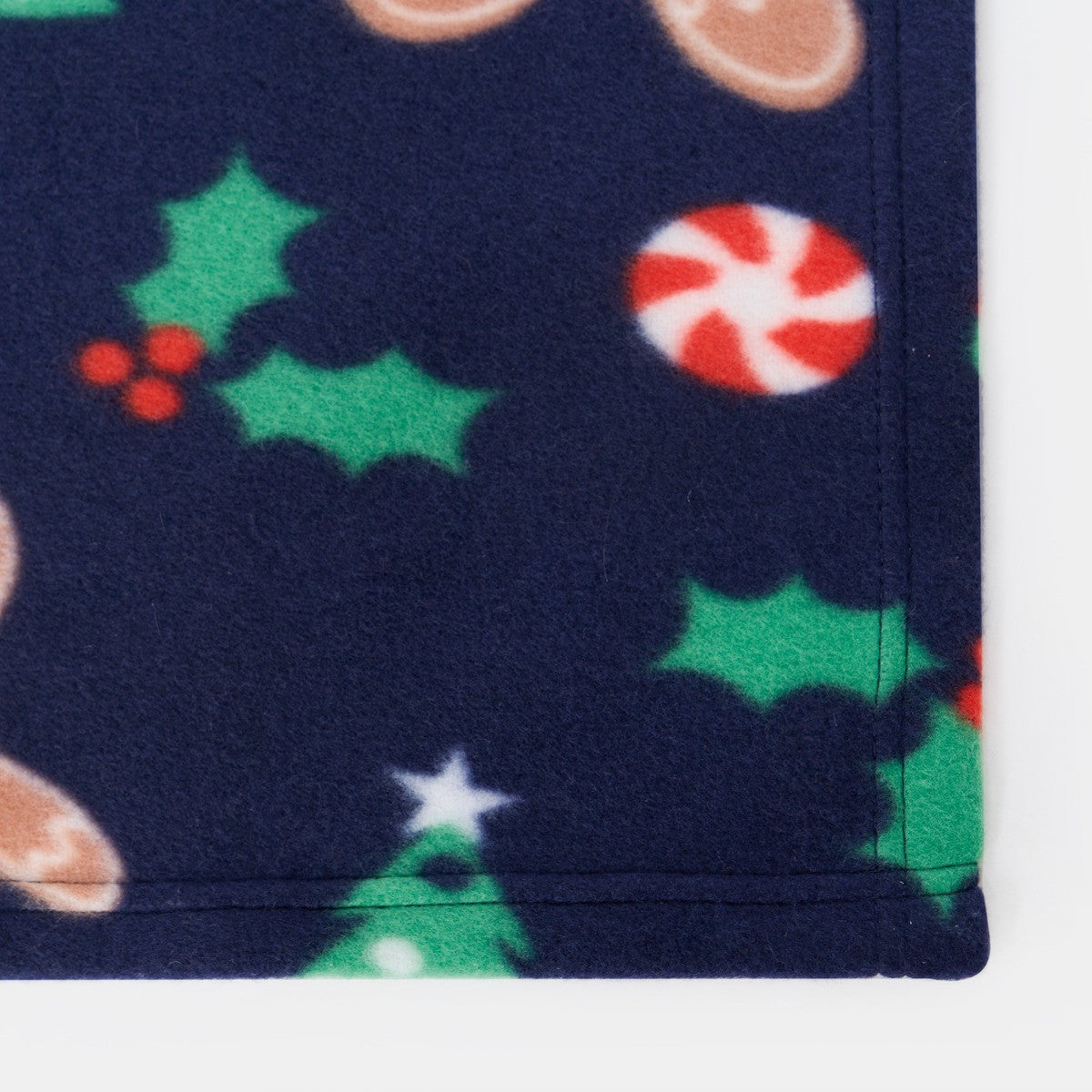 detailed close up of gingerbread print fleece throw suitable for christmas home decor