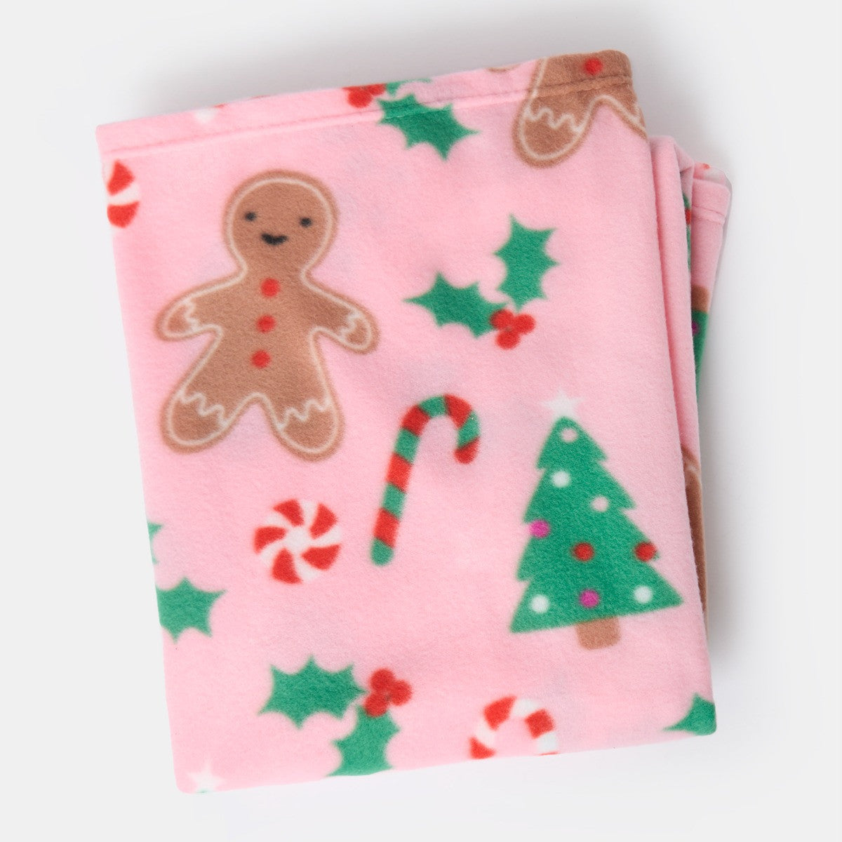 folded pink gingerbread fleece throw, neatly arranged with gingerbread man design visible