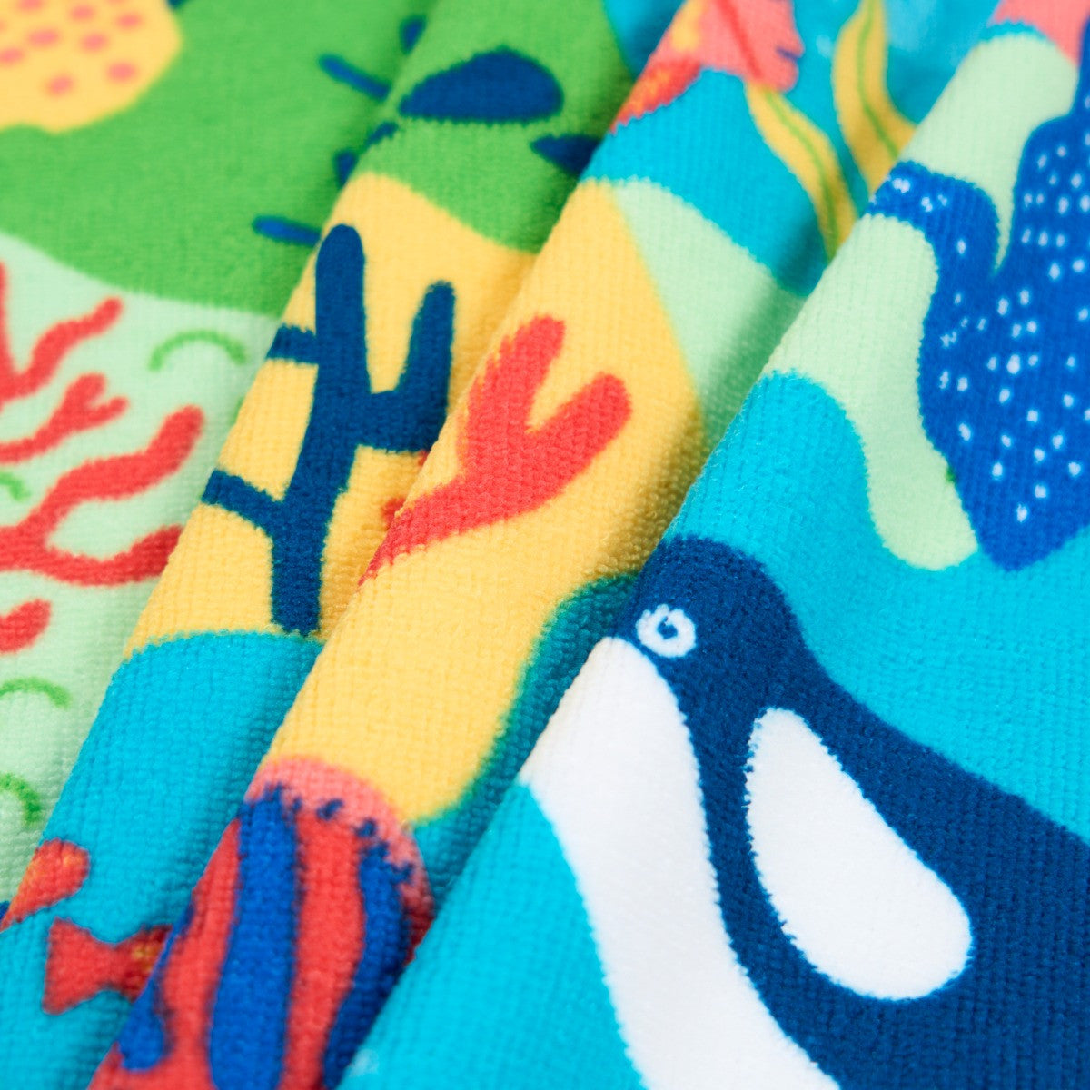 close-up of ocean-themed beach towel with sea creatures and vibrant colours