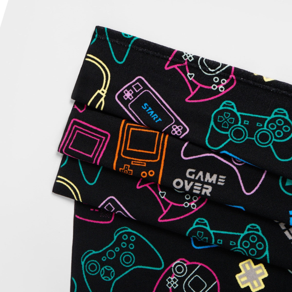 Close-up of console gamer design on black microfibre beach towel, children’s gaming print detail