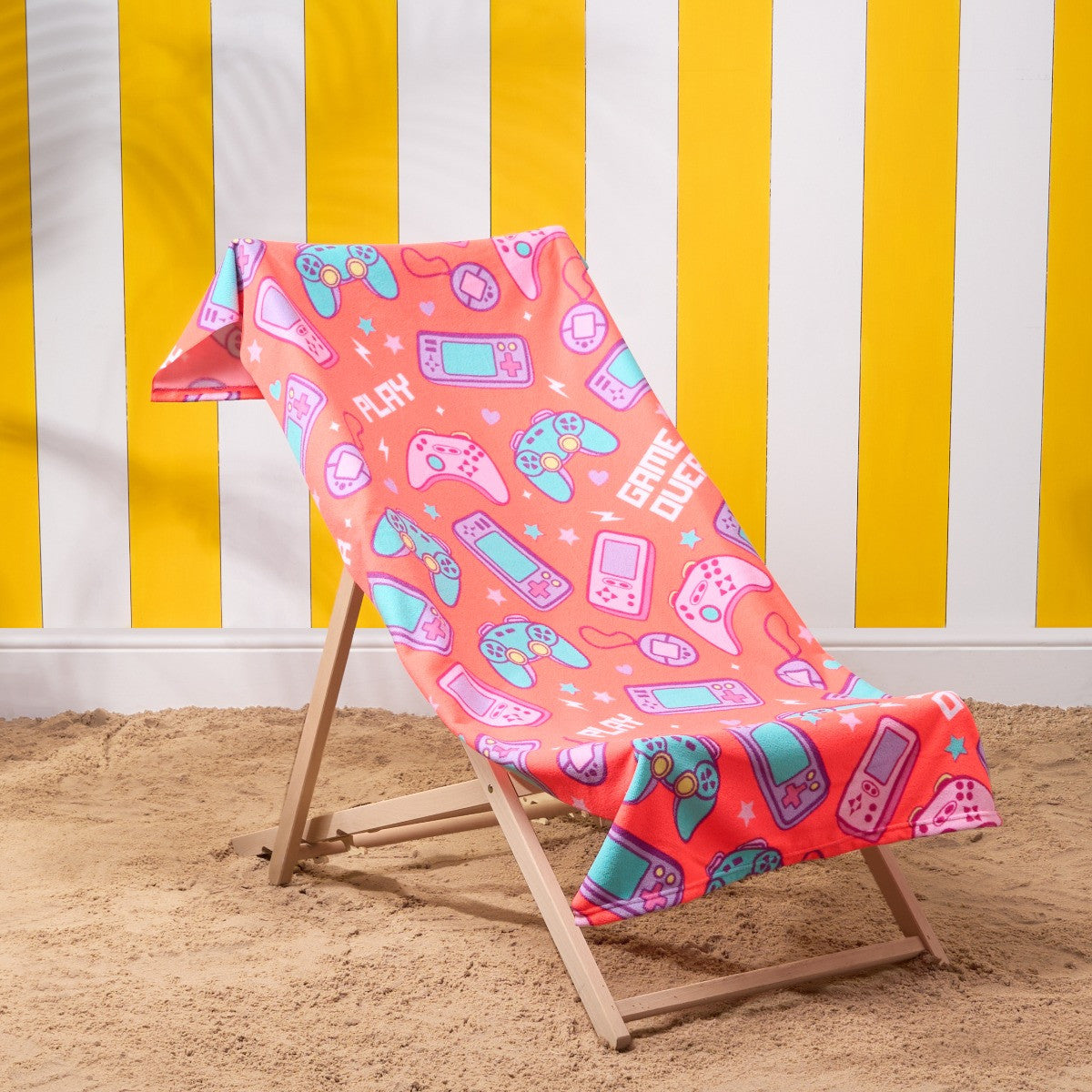 Gamer microfibre beach towel in coral on deckchair, lightweight quick-dry children’s gaming towel