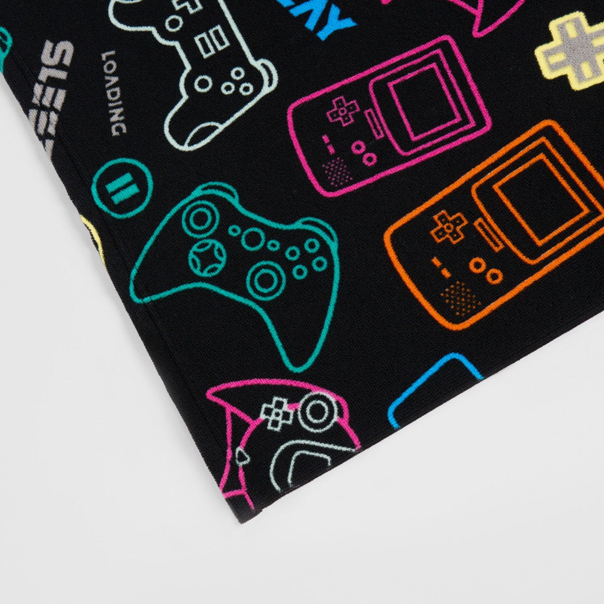 Detailed close-up of black gamer microfibre towel fabric, lightweight quick-dry children’s towel