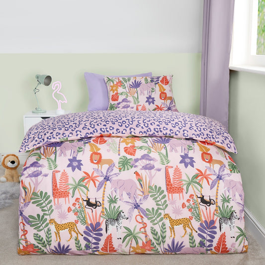 Safari print reversible double duvet cover set on bed with lions, giraffes and zebras on lilac background