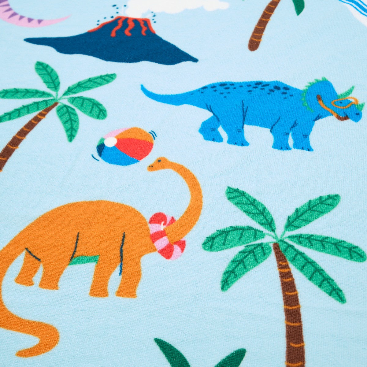 Detailed close-up of colourful dinosaur print on children’s microfibre beach towel