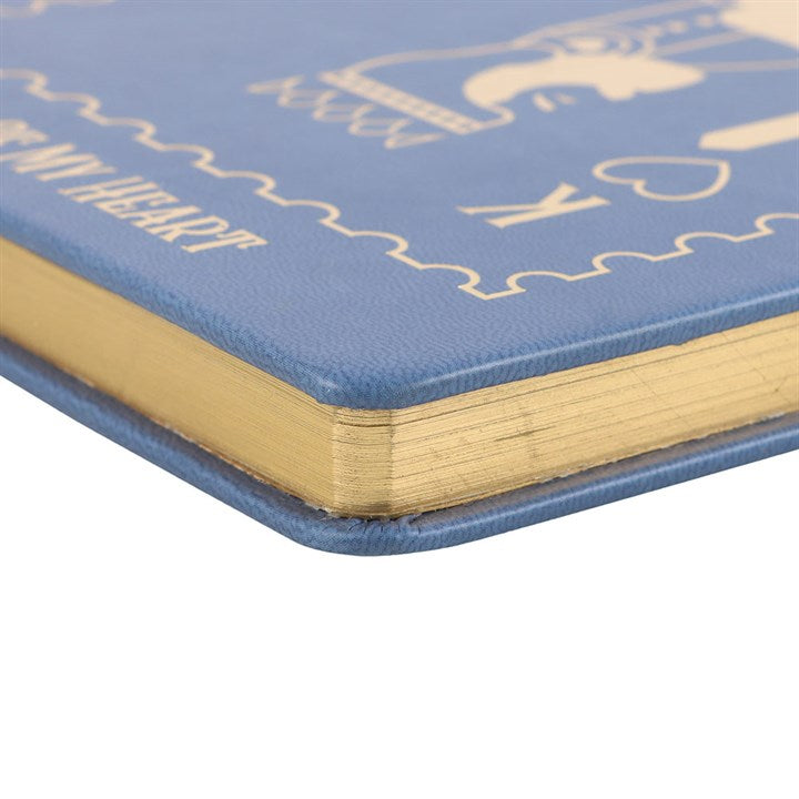 side view of king of my heart notebook showing decorative gold page edging