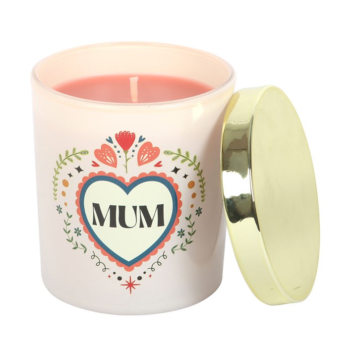 french tulip scented candle with lid resting beside jar showing folk style design