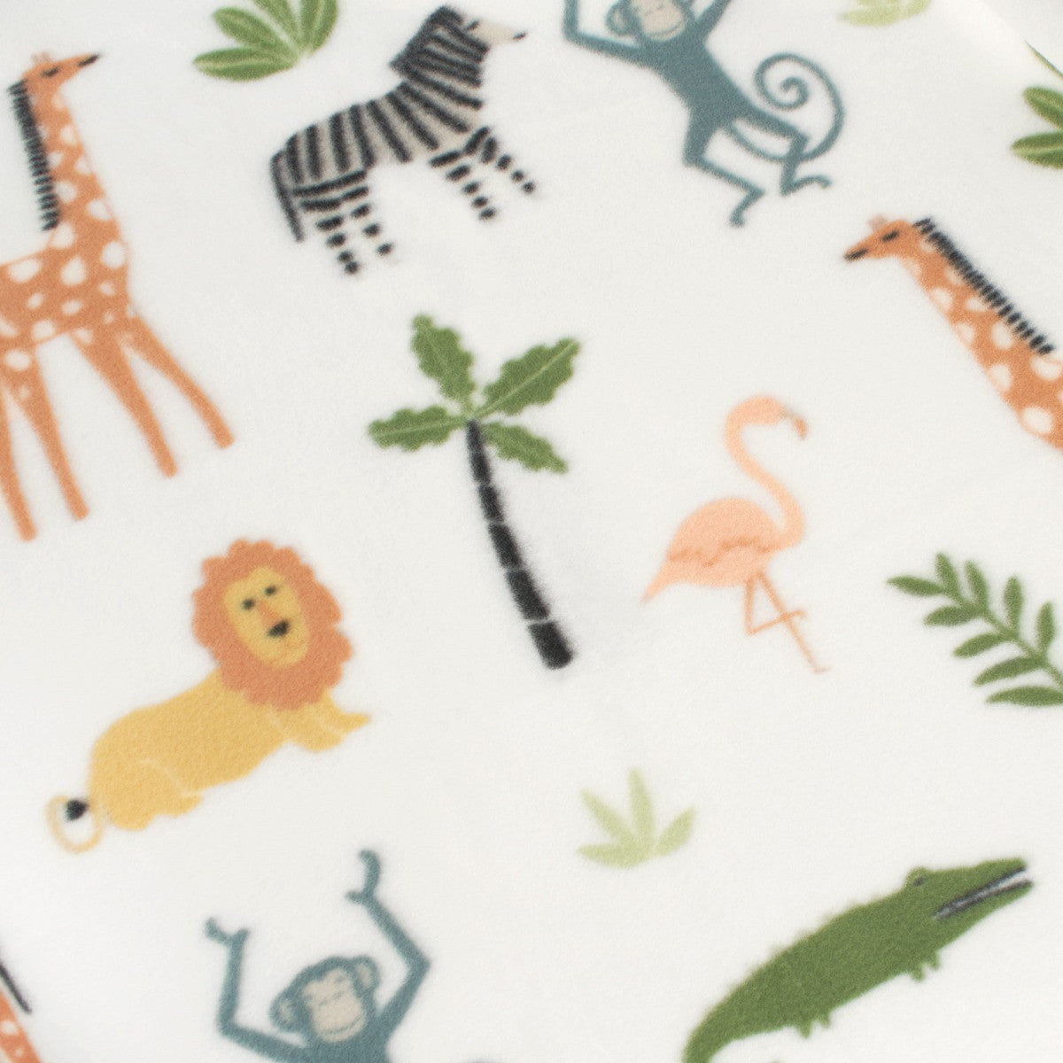 close-up of safari fleece throw print with lions, giraffes, and flamingos among foliage