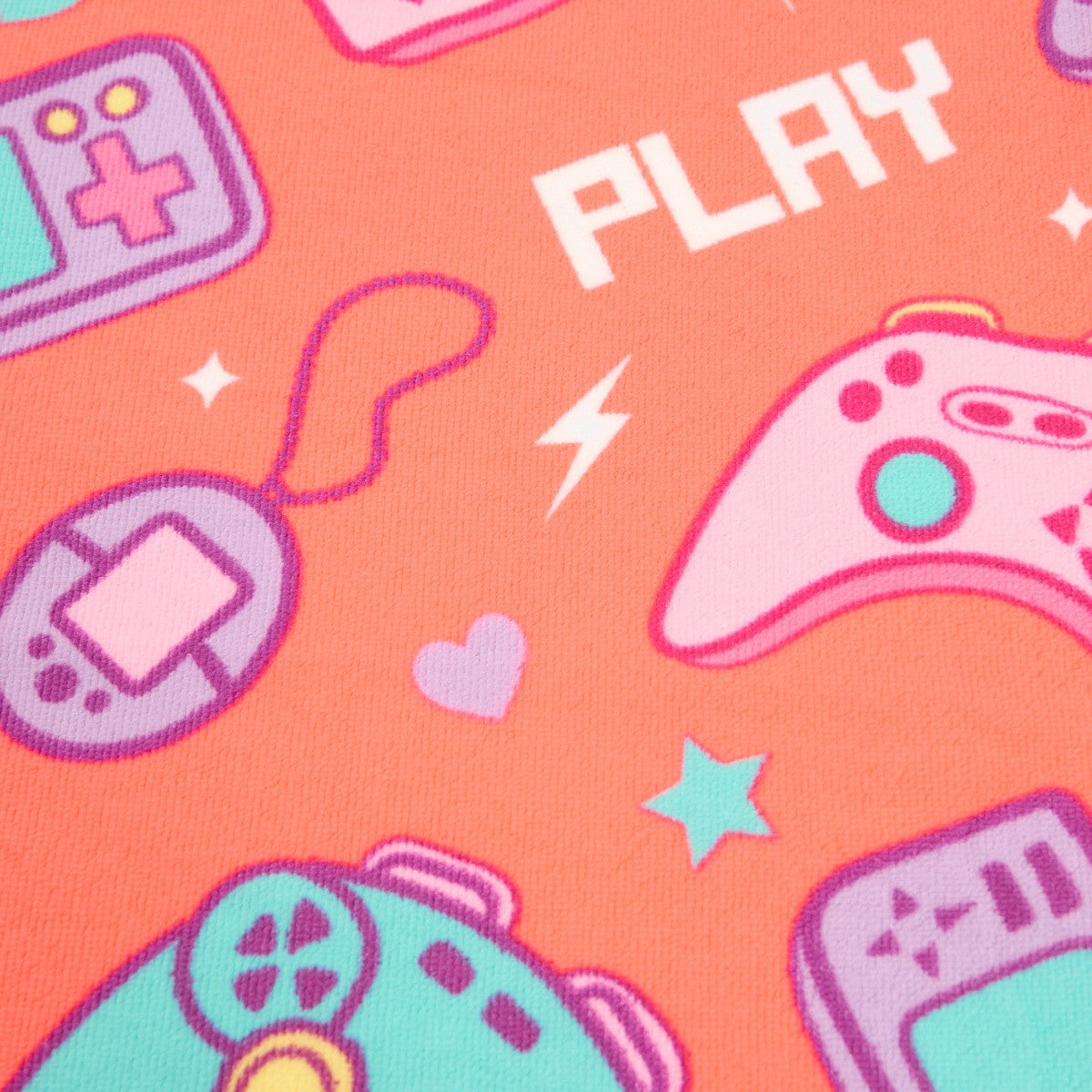 Close-up of console gamer design on coral microfibre beach towel, children’s gaming themed towel detail