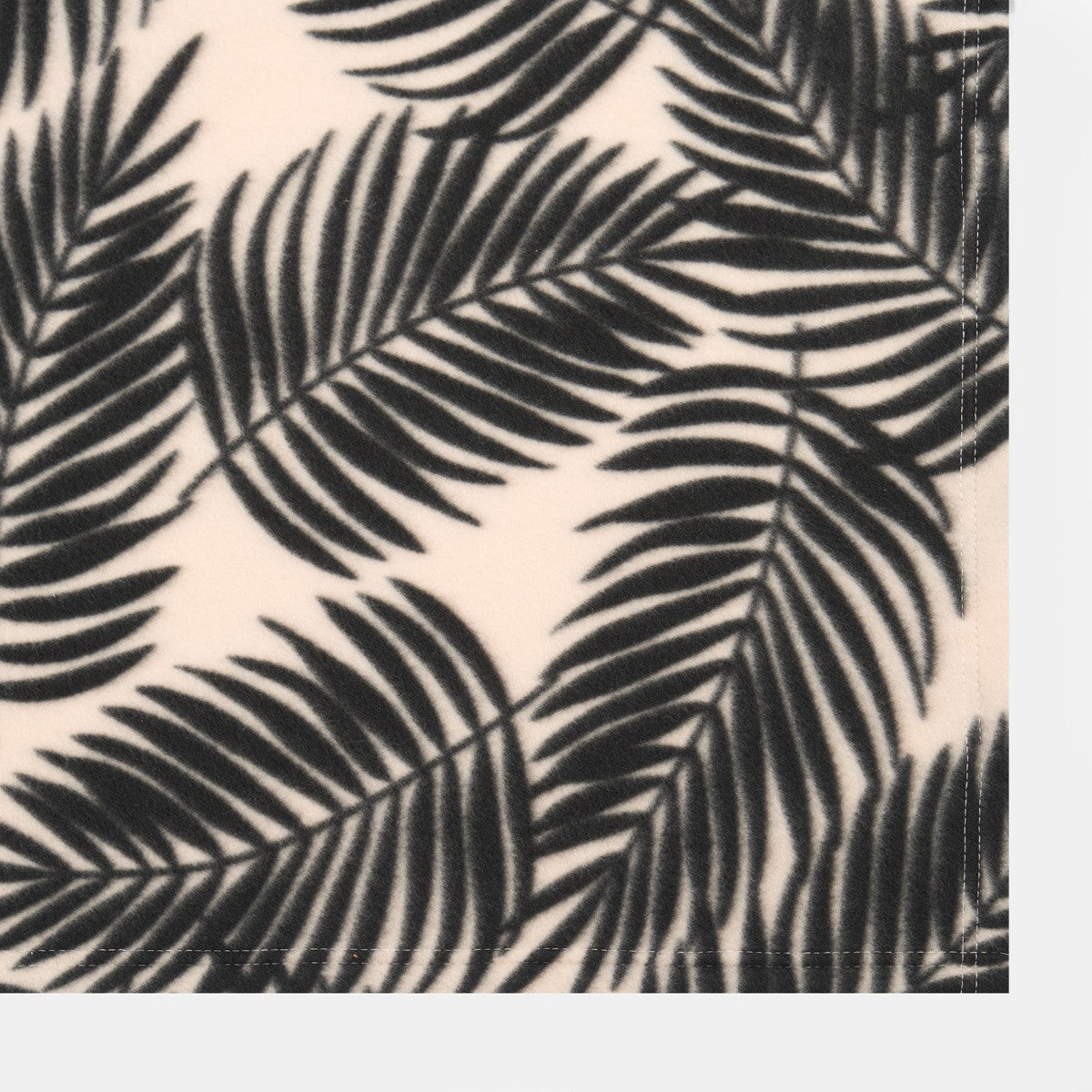 close up detail of palm leaf patterned fleece throw fabric texture
