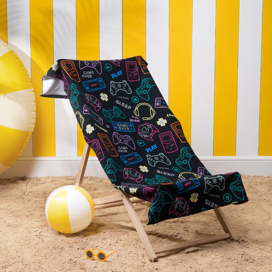 Console gamer microfibre beach towel in black displayed on a deckchair, children’s gaming themed towel