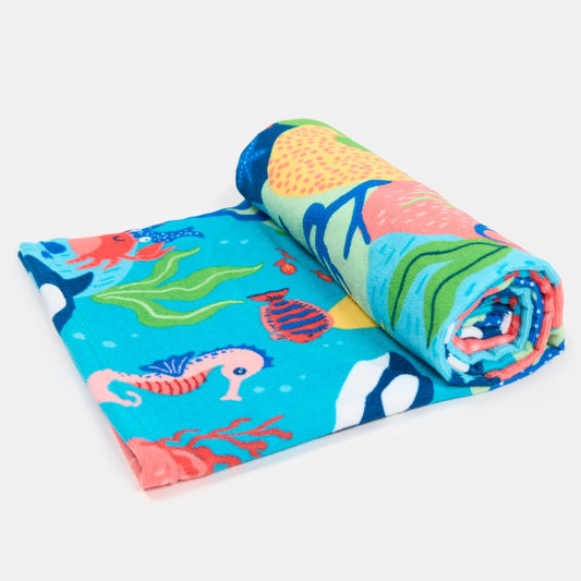 rolled beach towel with sea life design, showcasing compact storage