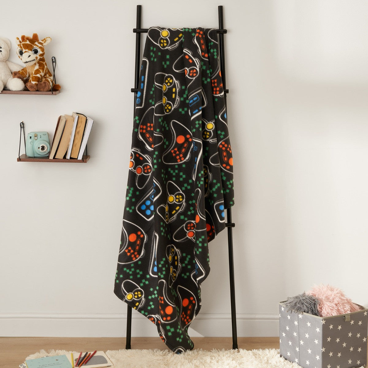 gaming fleece throw blanket displayed on hanger in cosy home setting
