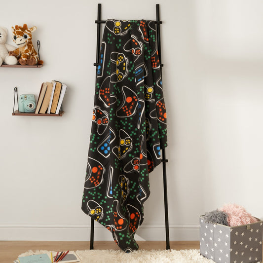 gaming fleece throw blanket displayed on hanger in cosy home setting