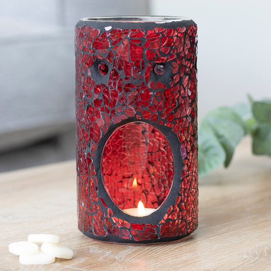red pillar crackle glass oil burner glowing with a lit tealight in a home setting