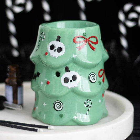 creepy christmas tree oil burner displayed on a festive tray