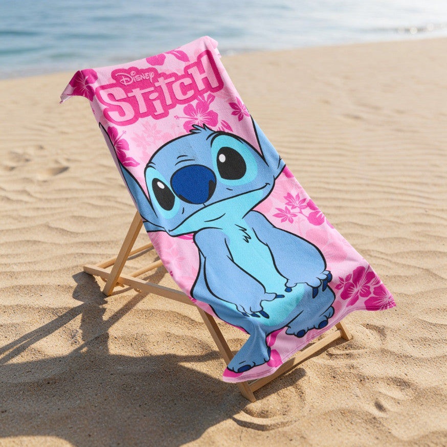 disney stitch pink microfibre beach towel displayed on a deck chair