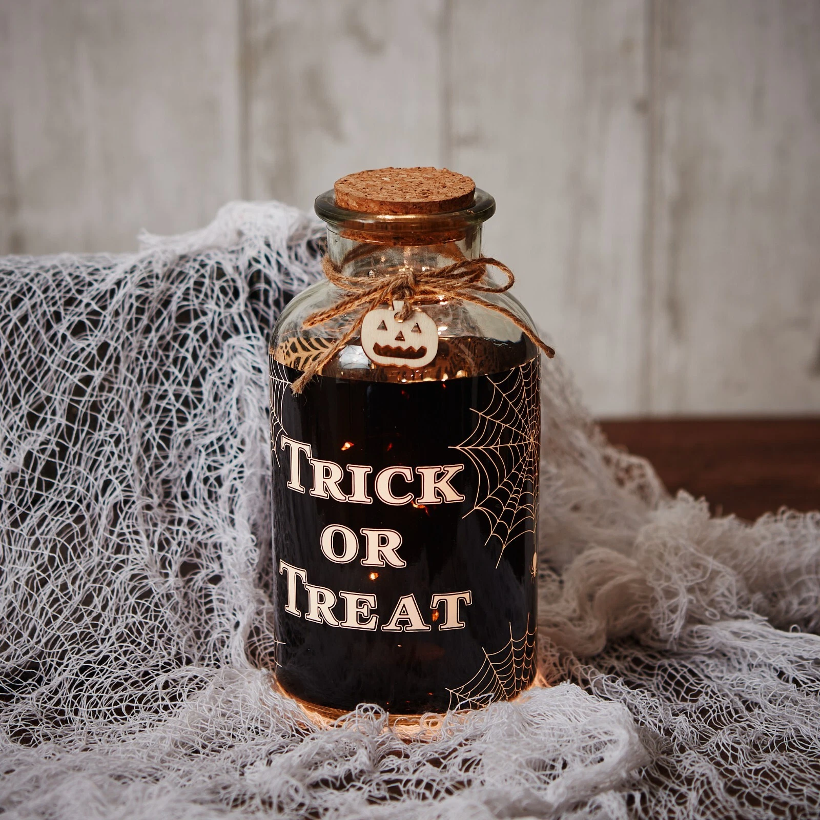 halloween trick or treat led decorative glass bottle light with cork and pumpkin detail