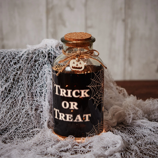 halloween trick or treat led decorative glass bottle light with cork and pumpkin detail