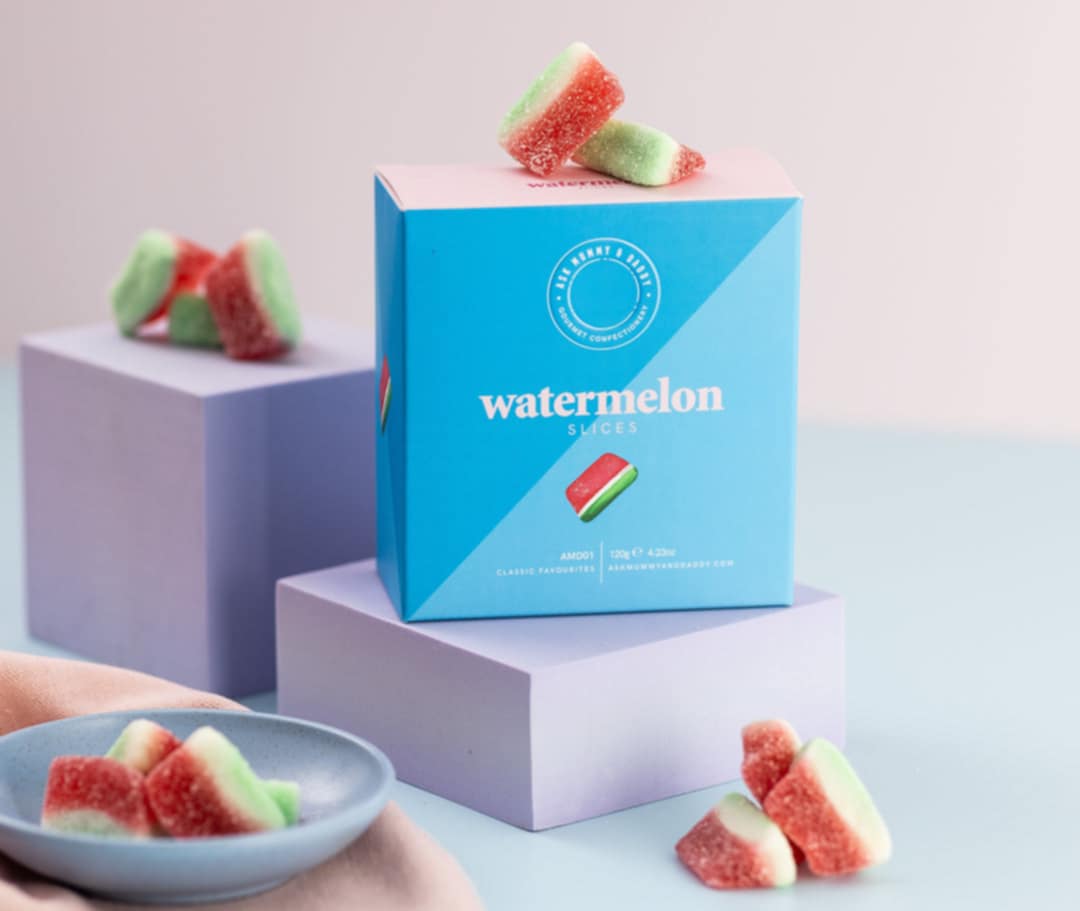 watermelon slices gift box front view with loose watermelon sweets scattered around
