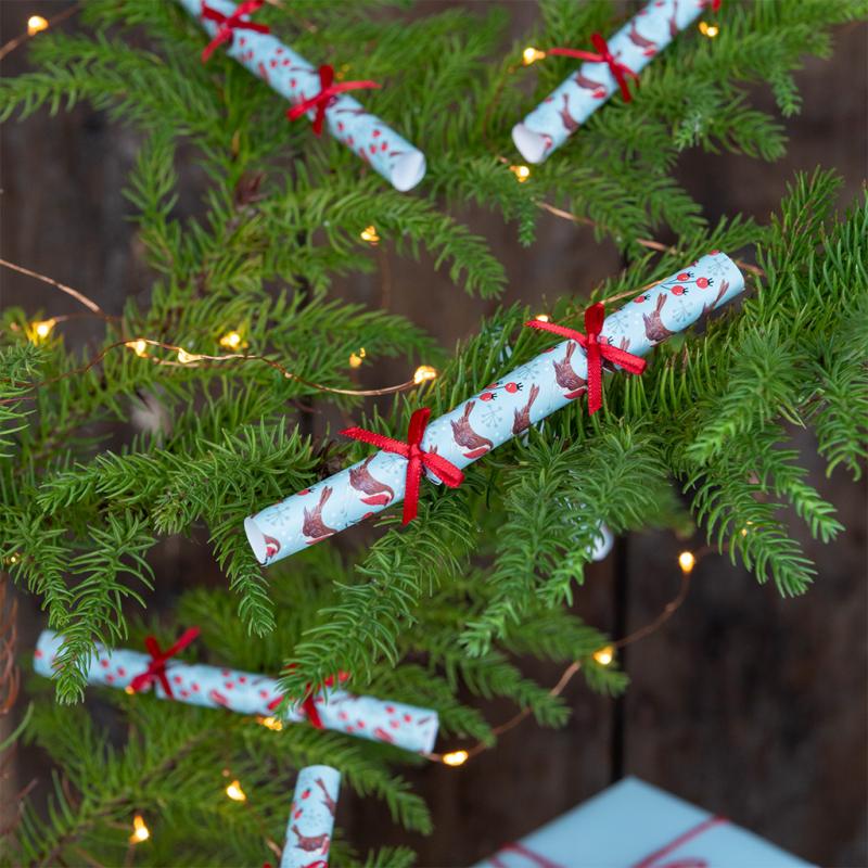christmas mini cracker tree decorations displayed hanging on decorated christmas tree