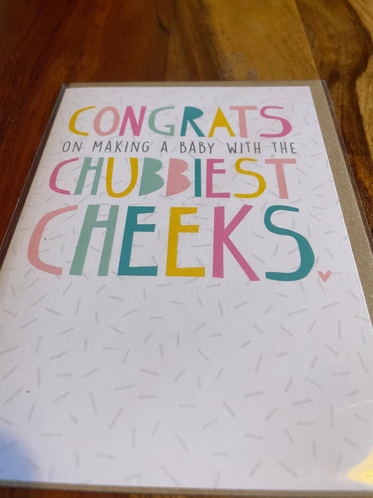 new baby greeting card with chubbiest cheeks text on white textured background