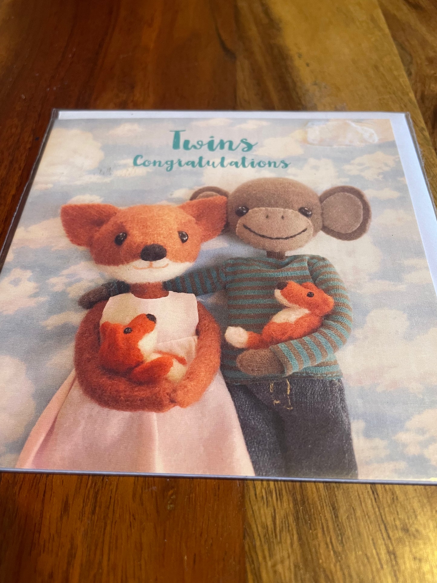 fox and monkey twins congratulations card with illustrated characters welcoming new baby twins